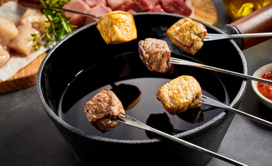 Fried tender beef, pork and veal over a fondue pot