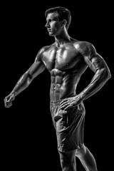 Fototapeta na wymiar Muscular and fit young bodybuilder fitness male model posing ove
