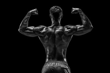 Fototapeta na wymiar Strong Athletic Man Fitness Model posing back muscles, triceps o