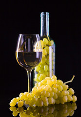 White grape in bottle and glass of wine
