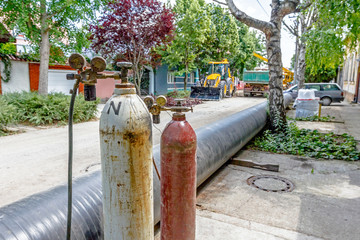 Red and white metal steel gas container with high pressure gauge meter and valves