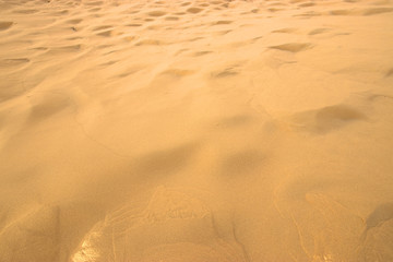 closeup of sand pattern of a beach in the summer.