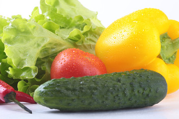 Assorted vegetables, fresh bell pepper, tomato, chilli pepper, cucumber and lettuce isolated on white background. Selective focus.