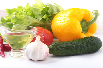 Assorted vegetables, fresh bell pepper, tomato, chilli pepper, cucumber, olive oil, garlic and lettuce isolated on white background. Selective focus.