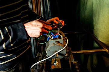 Repair of machine tools. Worker hands in workshop