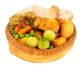 Roast chicken dinner in a large Yorkshire pudding isolated on a white background