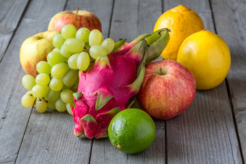 Exotic and traditional fruits on a wooden table