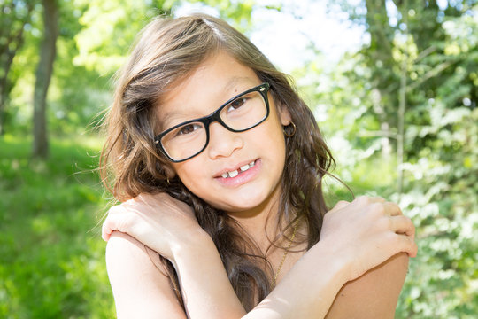 cheerful girl with glasses and a beautiful smile