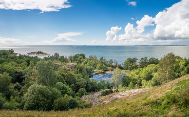 Fototapeta na wymiar Scenic landscape with sea and lush foliage at bright summer day in Finland