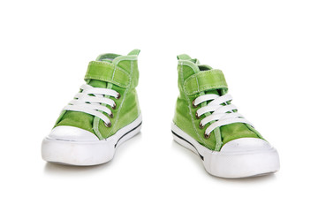 Green sport shoes for kid isolated on white background