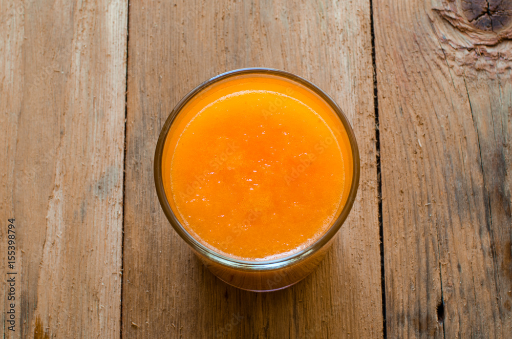 Wall mural Pumpkin Smoothie. Healthy blended juice on rustic wooden table. Shot on daylight