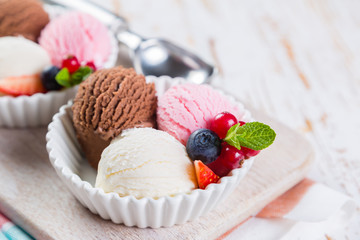 Selection of colorful ice cream scoops in white bowls