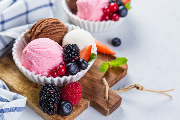Selection of colorful ice cream scoops in white bowls