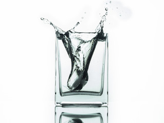 Water splash in glass isolated on white background