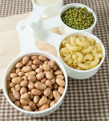 Pasta, Rice, Peanuts and Mung Beans in Measuring Spoons