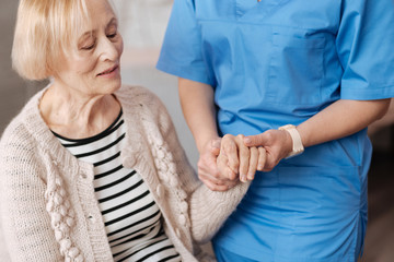 Feeble nice lady having her pulse checked