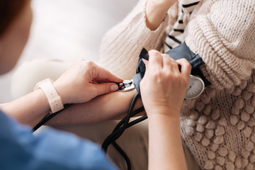 Precise focused doctor obtaining blood pressure measurements