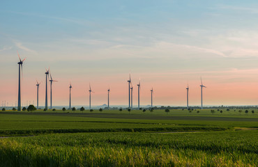 Wind generators produce environmentally friendly energy, a beautiful summer evening © igorgeiger