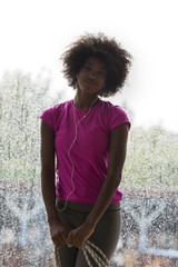 portrait of young afro american woman in gym while listening music