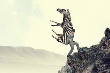 Businessman carrying zebra . Mixed media © Sergey Nivens