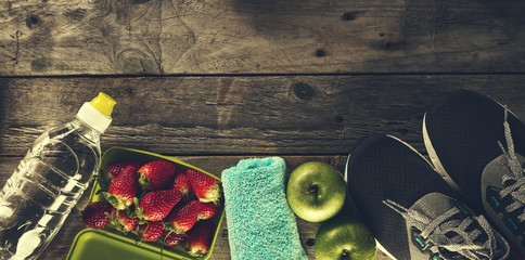Healthy Life Sport Concept. Sneakers with Apples, Towel and Bottle of Water on Wooden Background....
