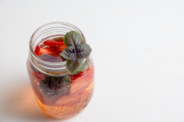Fresh cocktail with strawberry and basil in glass. Shallow depth of field.