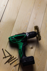 Screwdriver, nails and meter on wooden background