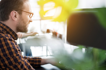 Active worker using computer in office