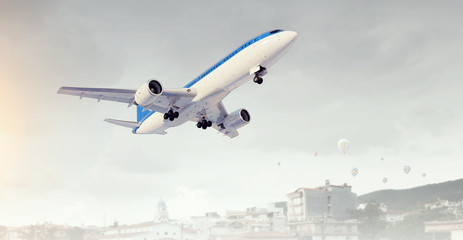 Airplane in day sky. Mixed media