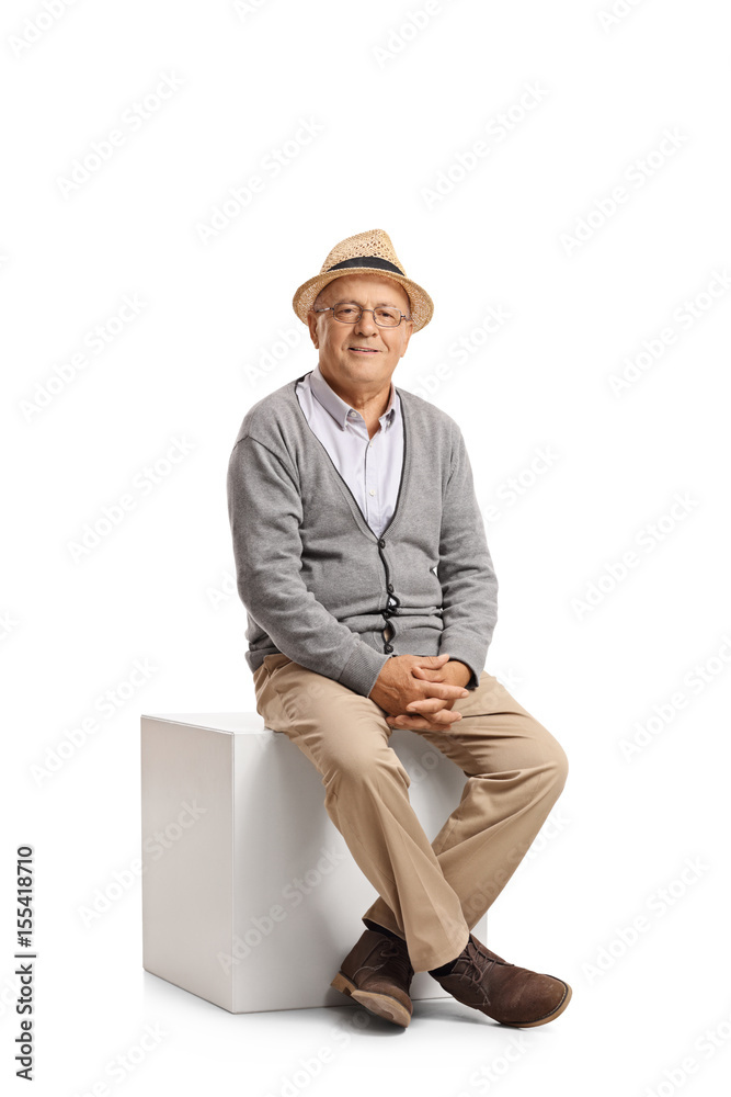 Wall mural senior sitting on a cube