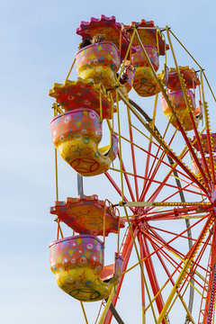 carousel ferris wheel against a blue sky