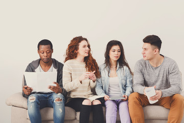 Diverse young students preparing for exam at home