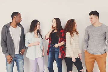 Fototapeta premium Group of diverse students standing in line indoors
