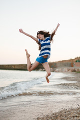 Happy young woman having fun in water of sea outdoor
