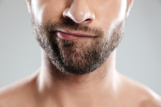 Cropped image of a doubtful bearded mans face