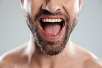 Cropped image of excited mans half face with naked shoulders