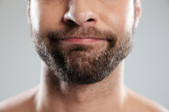 Cropped image of a doubtful bearded mans face
