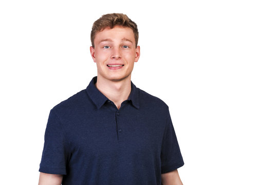 Man in navy polo t-shirt on white background with smile.