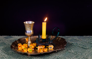 jewish holiday Hanukkahand wooden dreidels