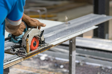 Man working with circular saw in site - soft focus.