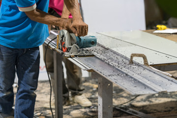Man working with circular saw in site - soft focus.