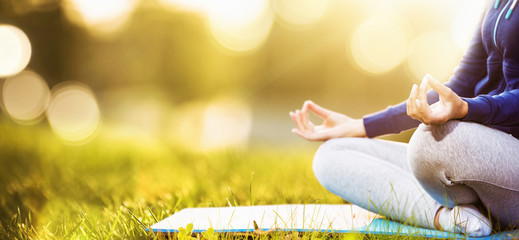 Yoga woman meditating at sunset