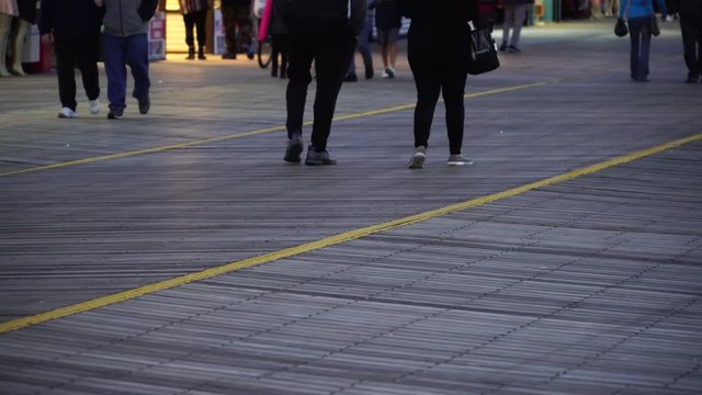 May 6, 2017 - Atlantic City, NJ, USA. Tourists walk along the famous boardwalk. 4K