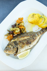 Grilled fish, served with vegetables and potato