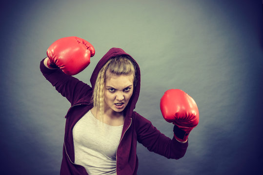 Angry woman wearing boxing gloves