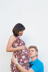 Husband listening to his wife's belly