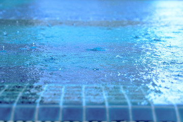 Heavy rain in the blue swimming pool