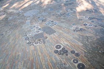 The sidewalk is made of automotive gear and pavers in Barcelona. Sightseeing on montjuïc hill in Barcelona. Spain.