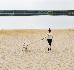 woman with dog and lake 