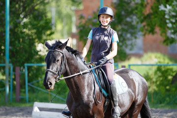 Young rider girl on horse at dressage competition. Equestrian sport background